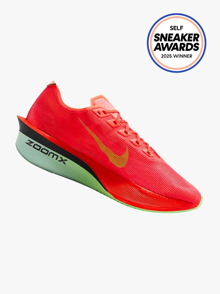 Neon redish pink sneaker with a green nike logo and mint green sole. In the top corner is the SELF Sneaker Awards logo.